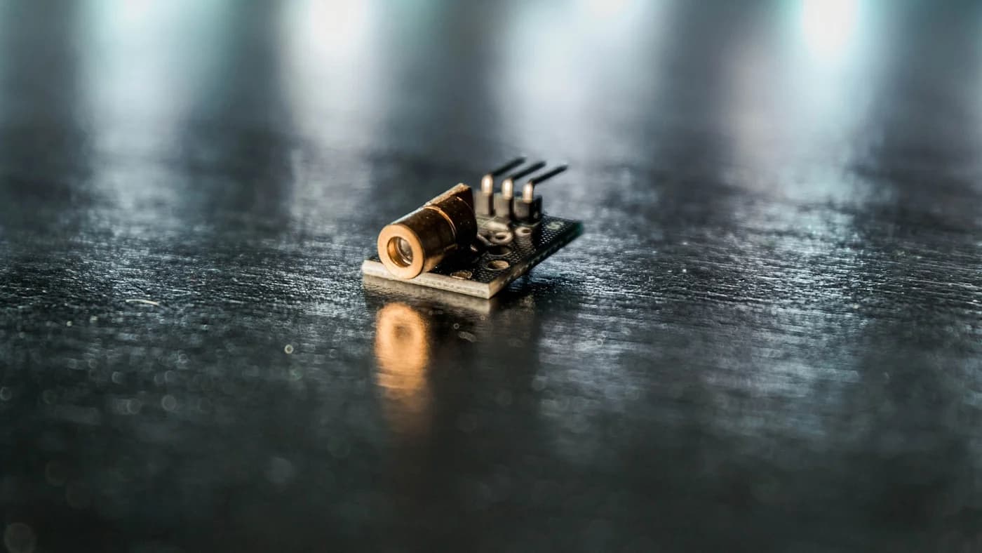 Tiny backlit electronic component on a dark surface, representing small efficient budget-tier AI models
