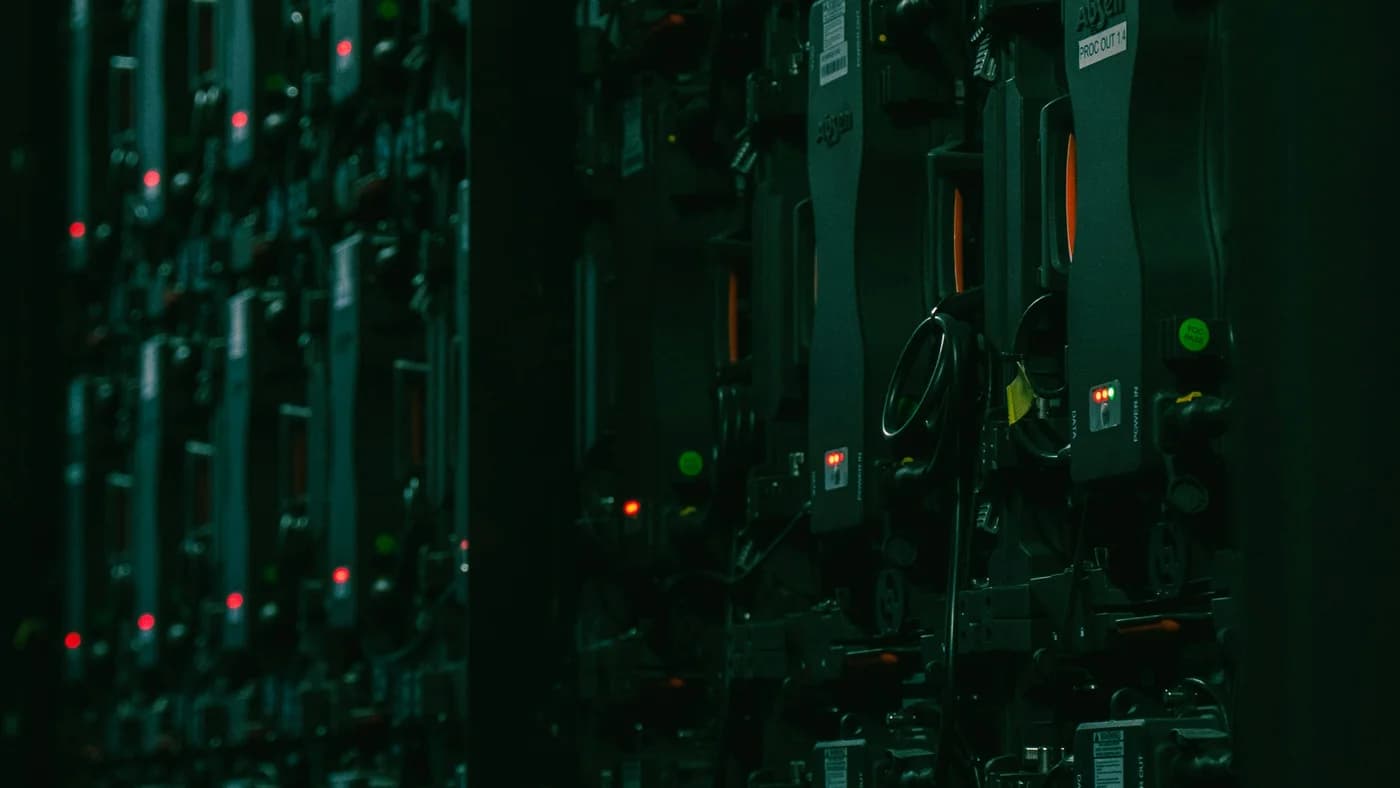 Dark server rack room with red and green LED status lights