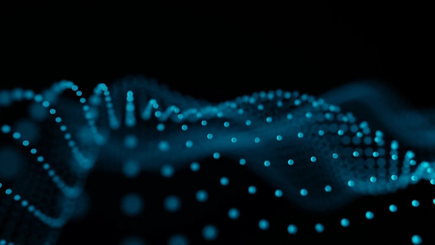 Abstract blue glowing dots forming wave patterns on a dark background