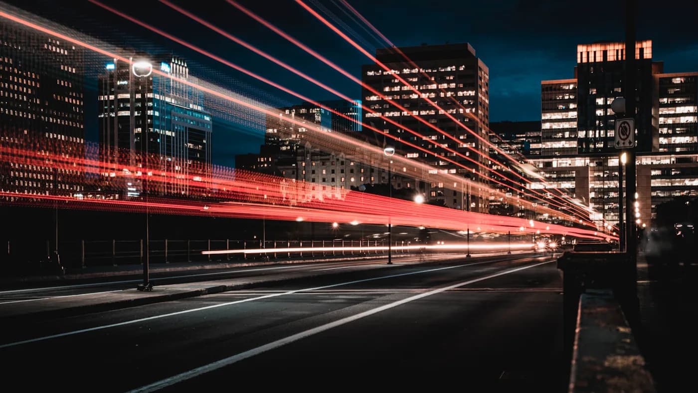 Night highway light trails streaking toward a city, illustrating GPT-5.5 priority processing speed