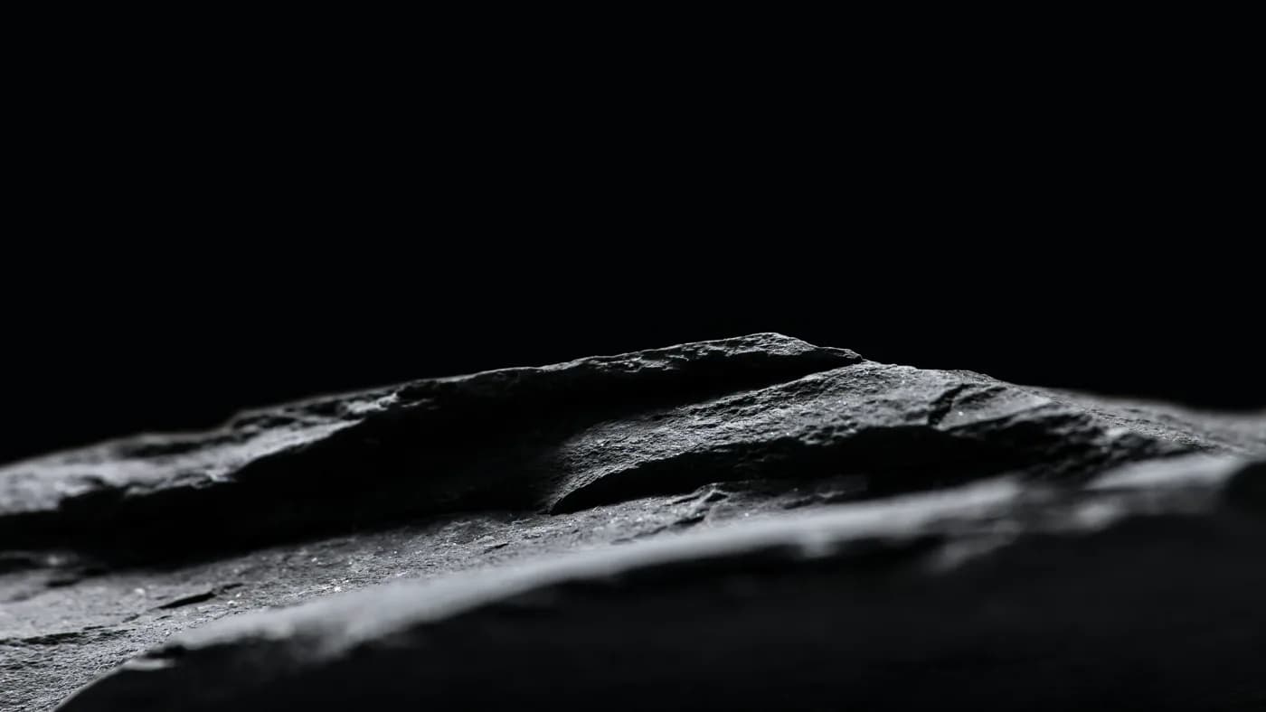 Dark abstract ridge lit from one side, representing the single line that changed on the Grok rate card