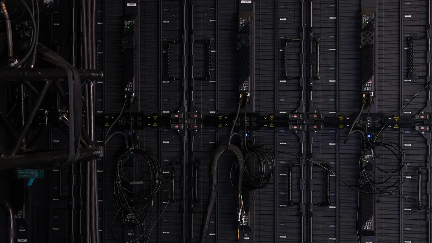 Dark server modules in a dense rack with only a few status lights lit, evoking sparse expert activation