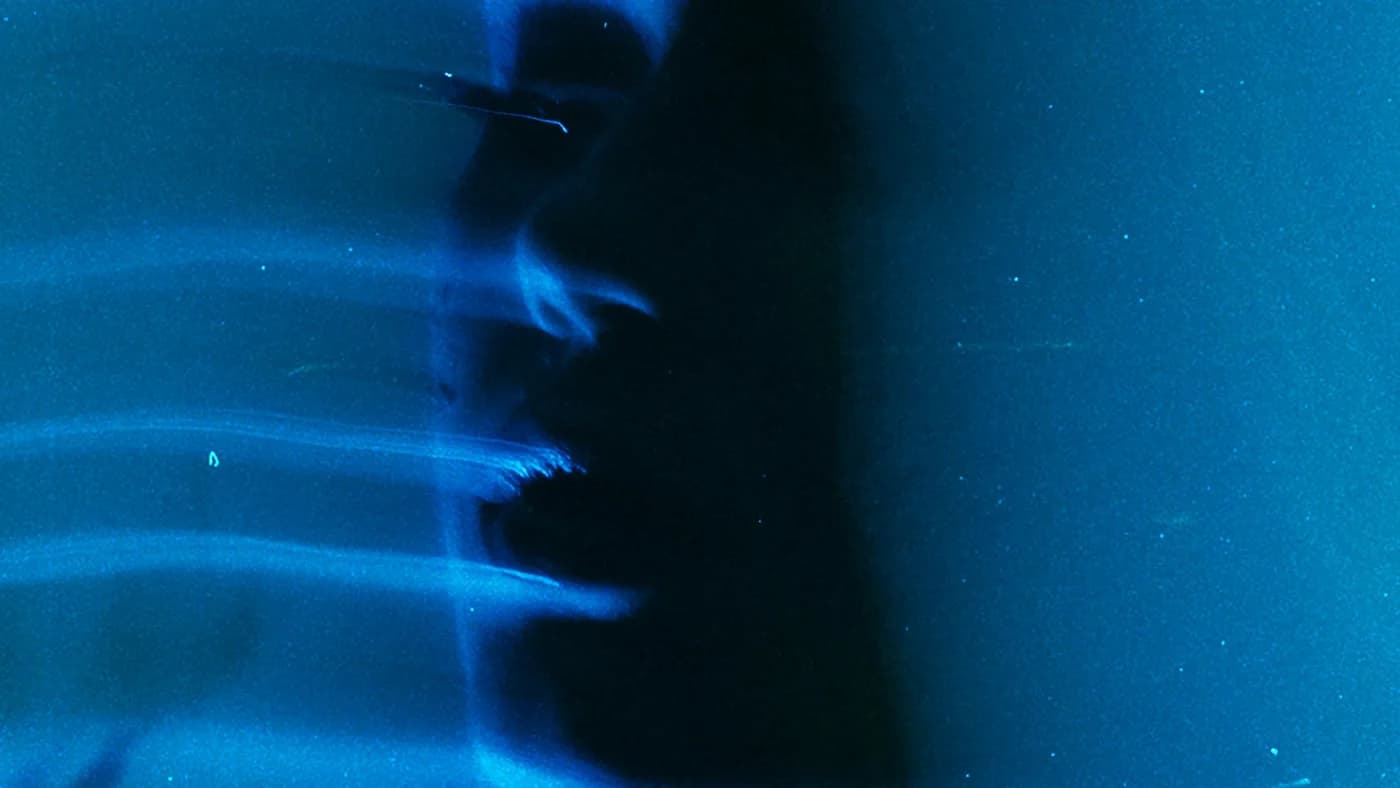 Blue light streaks against a dark background, suggesting speed and motion