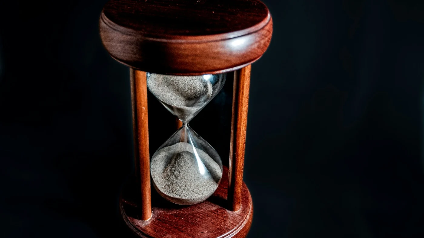 An hourglass draining against a black background, representing an expiring introductory price
