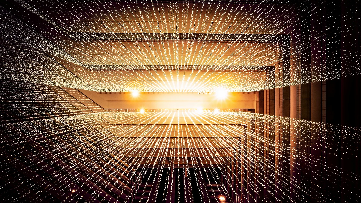 Abstract light tunnel with radiating golden fiber optic lines on dark background